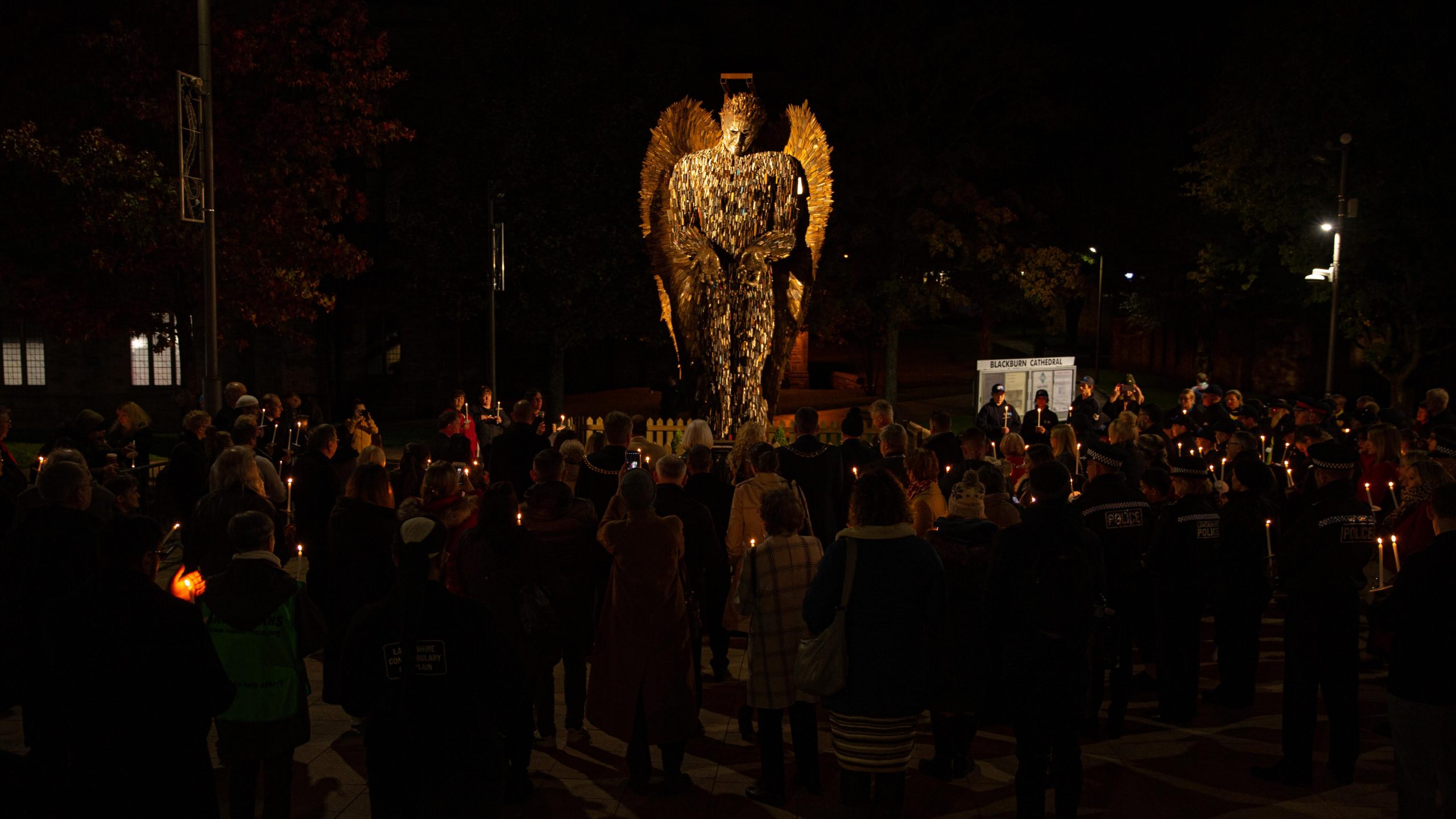 People holding candles at Knife Angel peace vigil 